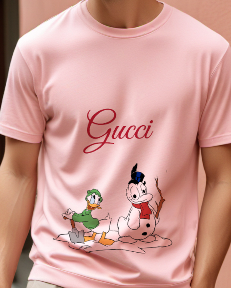 Blush Pink Donald Duck Shovels Snow Beside Snowman Graphic T-Shirt - model wearing view
